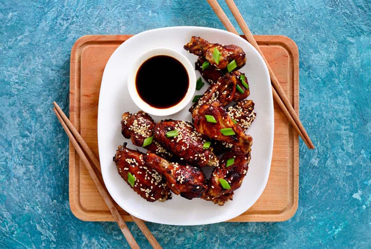 Chicken wings cooked on asian style recipe, view from above, flatlay composition