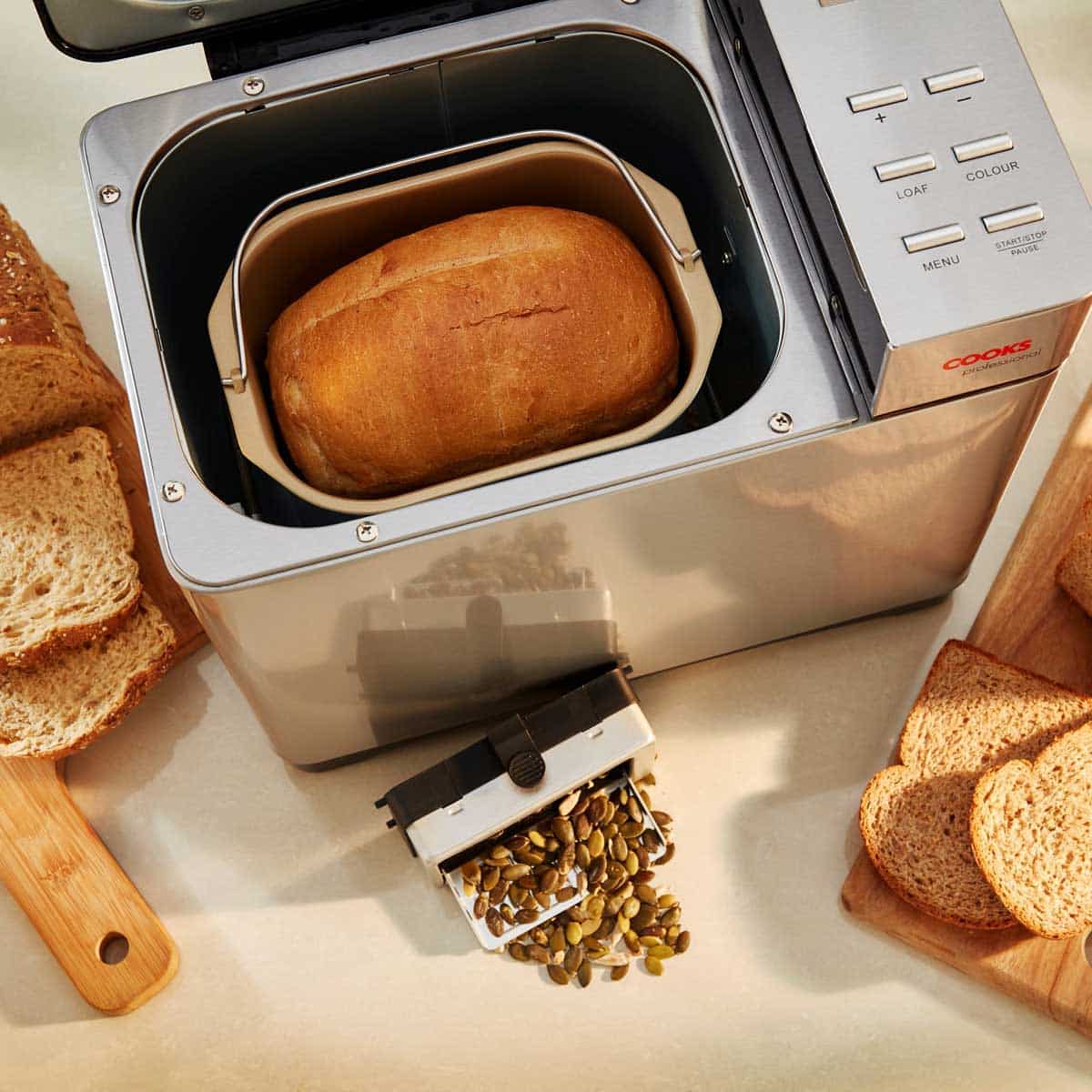 Bread maker with fruit and seed dispenser